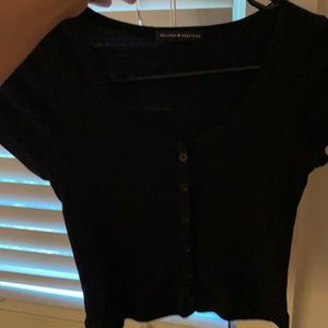 black crop top fitted with buttons on front!